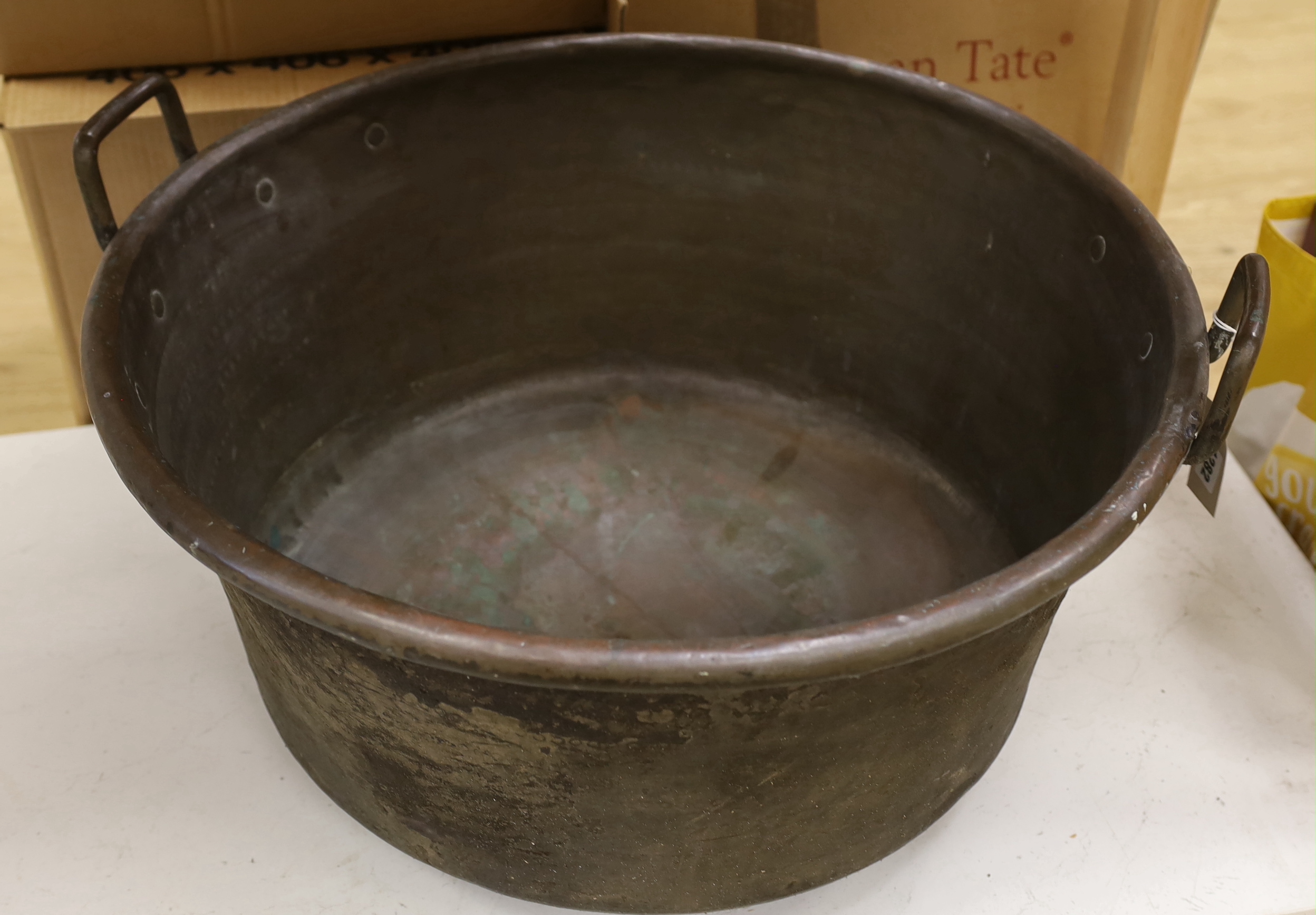 A large 19th century copper pot with twin handles, 69cm in diameter